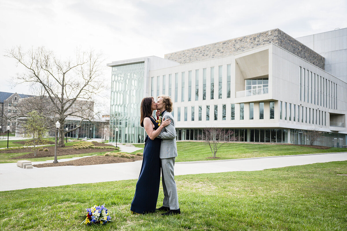 A couple on their elopement day kiss and embrace at the conclusion of their ceremony outside of the Moss Arts Center in Blacksburg, Virginia.