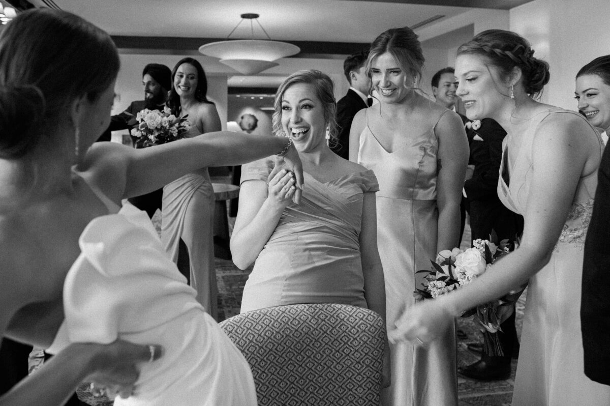Bridesmaids laughing and celebrating with the bride before the ceremony at Four Seasons Troon North, captured by an AZ wedding photographer.