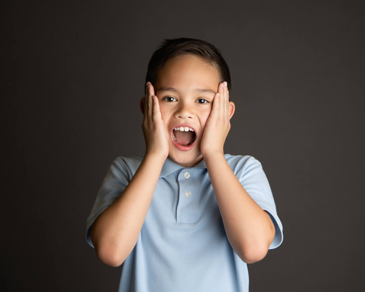 Las Vegas student in a light blue polo acting shocked for school pictures