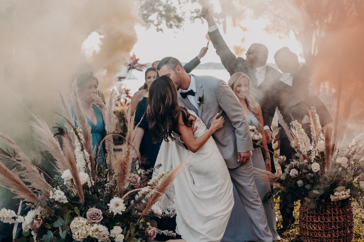 A Bride + Groom celebrate with their wedding party after their ceremony at the Palmetto Riverside Bed + Breakfast in Bradenton, Florida- by Angela Moon Photography. 