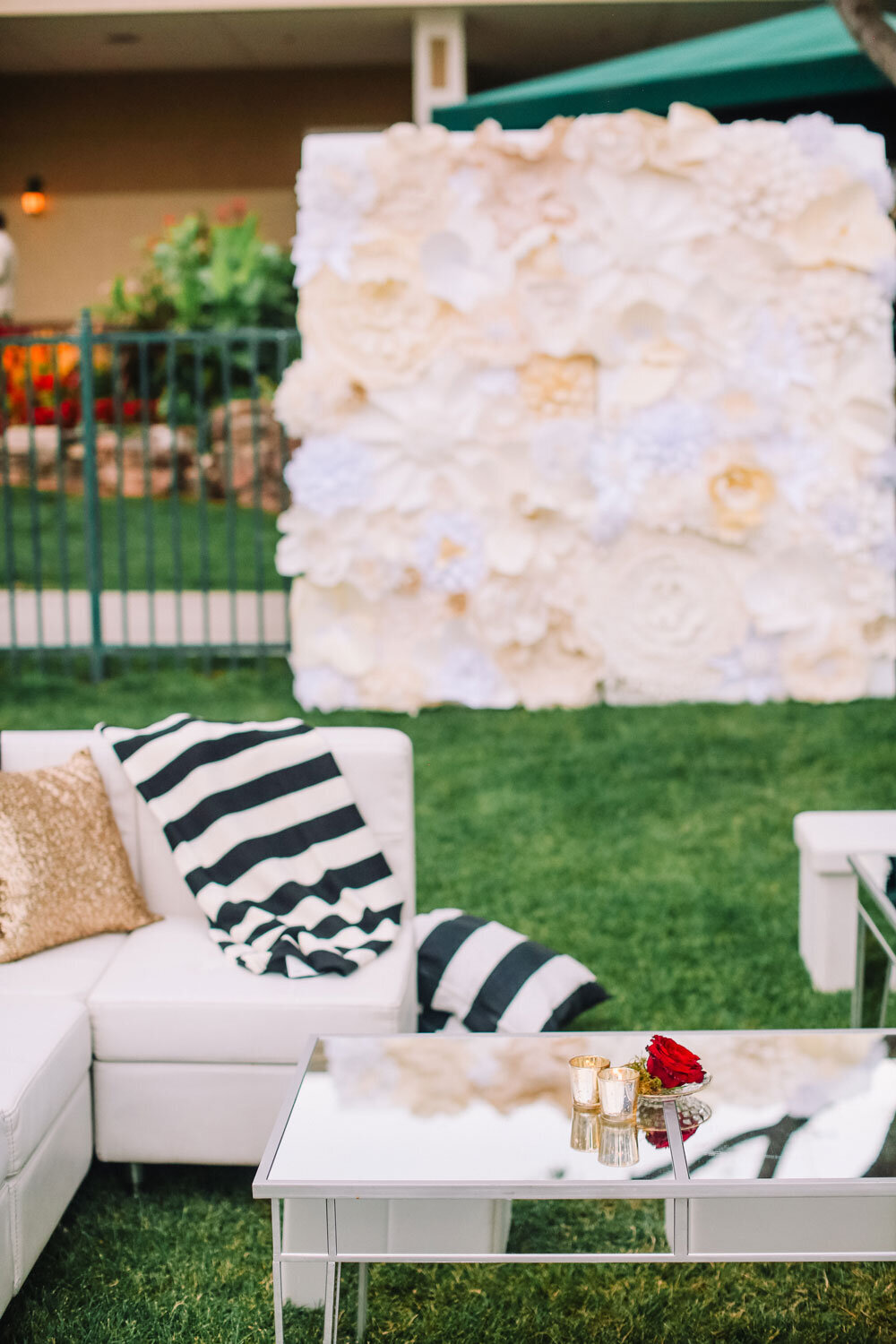 Outdoor lounge furniture and photo backdrop set up at a black tie wedding in Denver