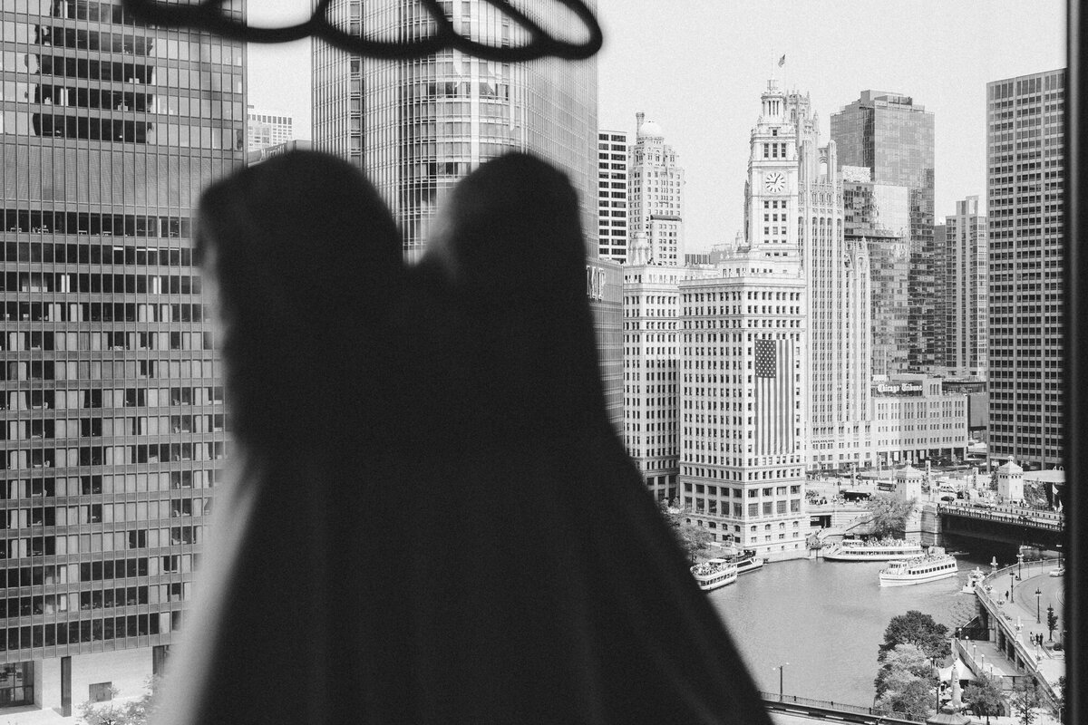  moody and artistic black and white wedding photo highlighting intricate dress details.