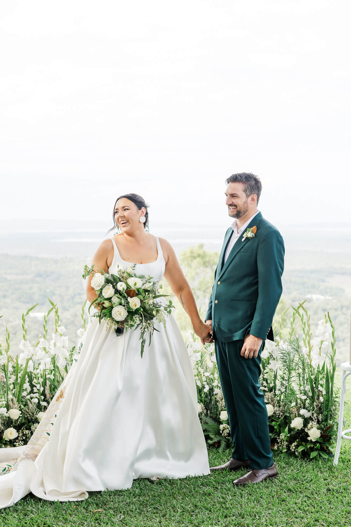 The Lookout Woodbury poviding a gorgeous backdrop for this bride and groom as they share a laugh during their wedding ceremony.