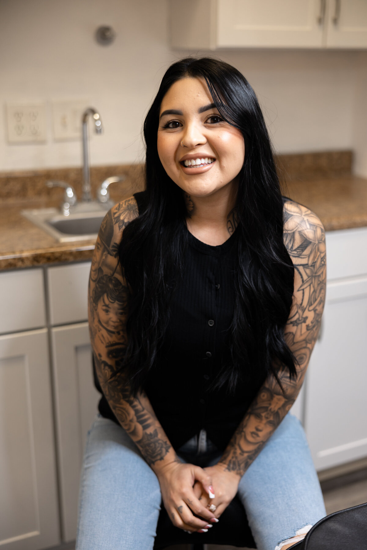 Tattooed beauty professional performing brow procedure with careful attention. Photograph by Yucaipa branding photographer Kaitlyn Dawn Photography.