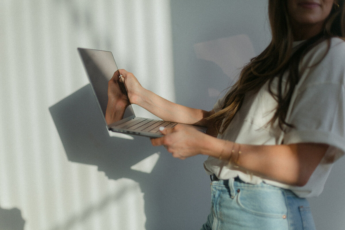 Sam holding laptop
