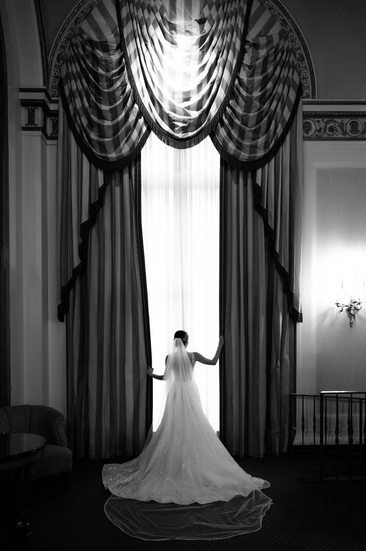 bride posing in the window at the omni