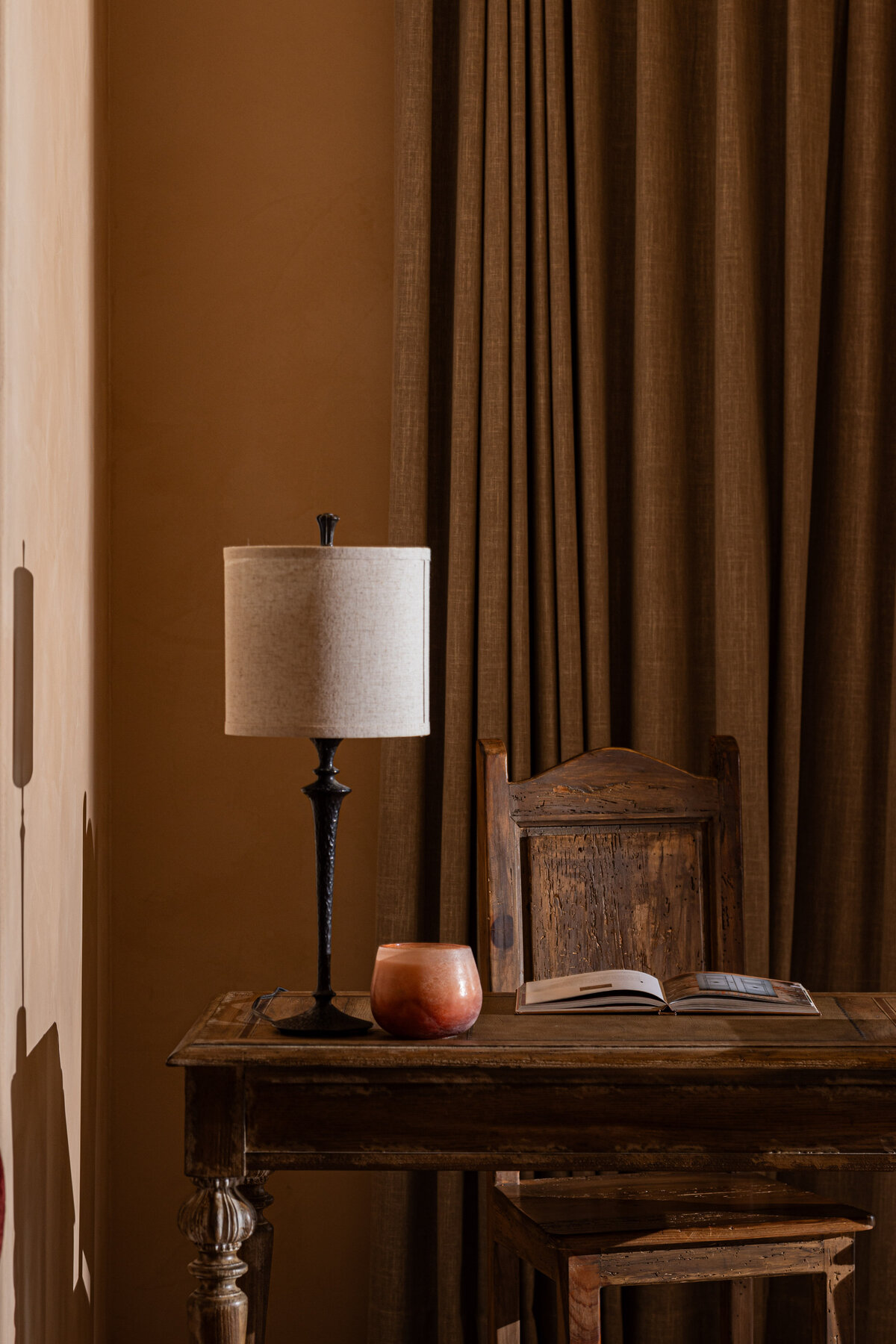 Interior photography of a traditional study with a wooden desk and ambient lighting