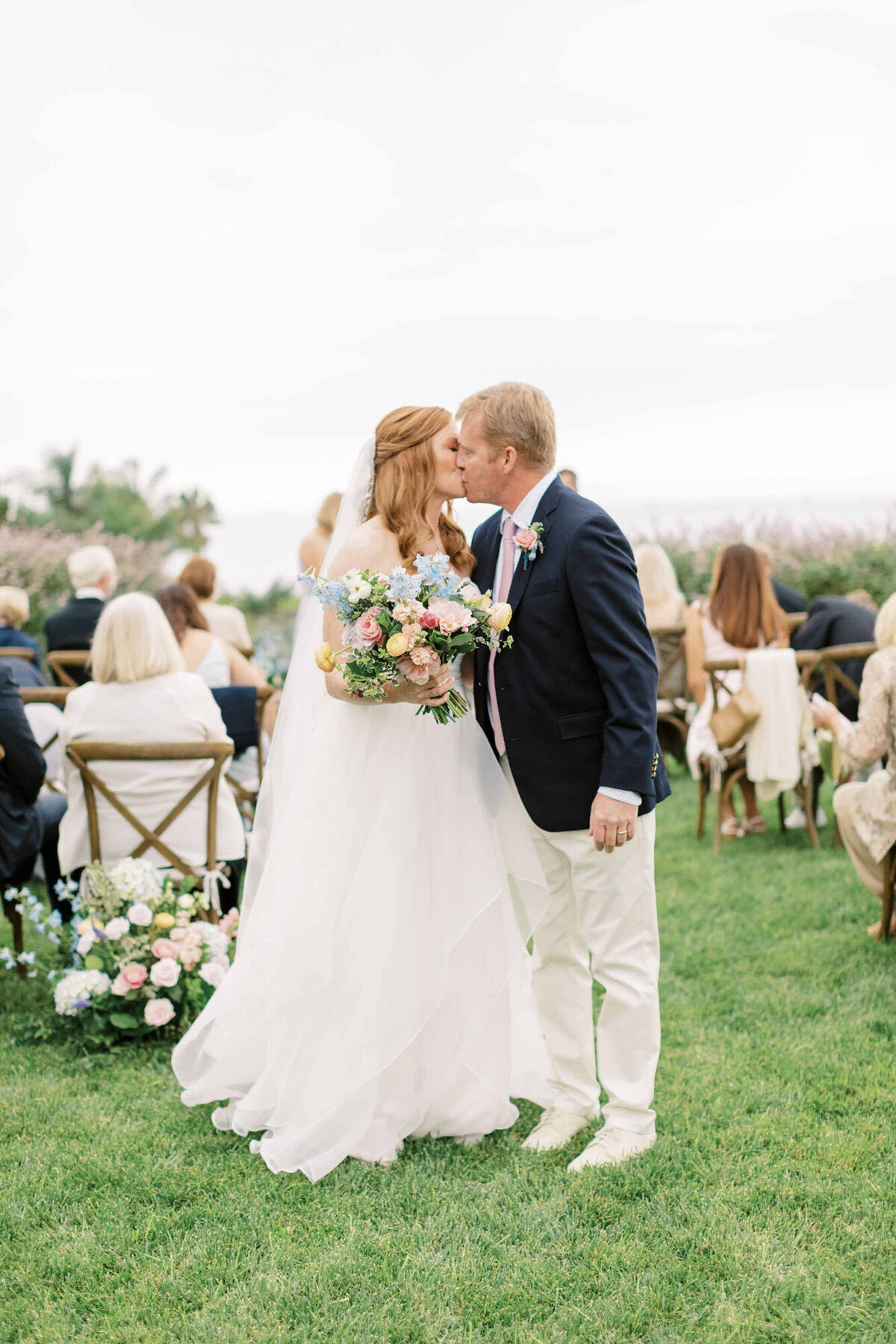 17santa-barbara-estate-wedding-planner-groom-white-pants-navy-blazer-bouquet-yellow-pink-coral-blue