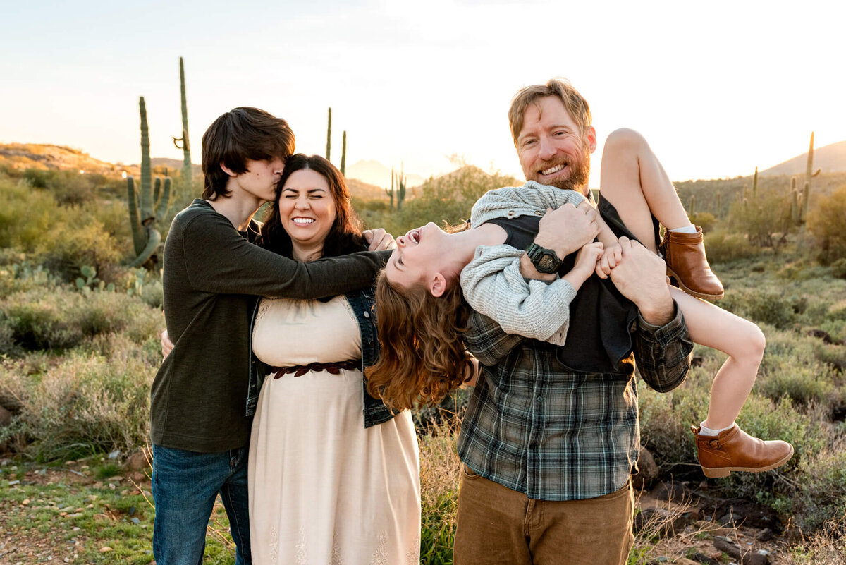 Family laughing and playing during photo session with Cactus & Pine Photography