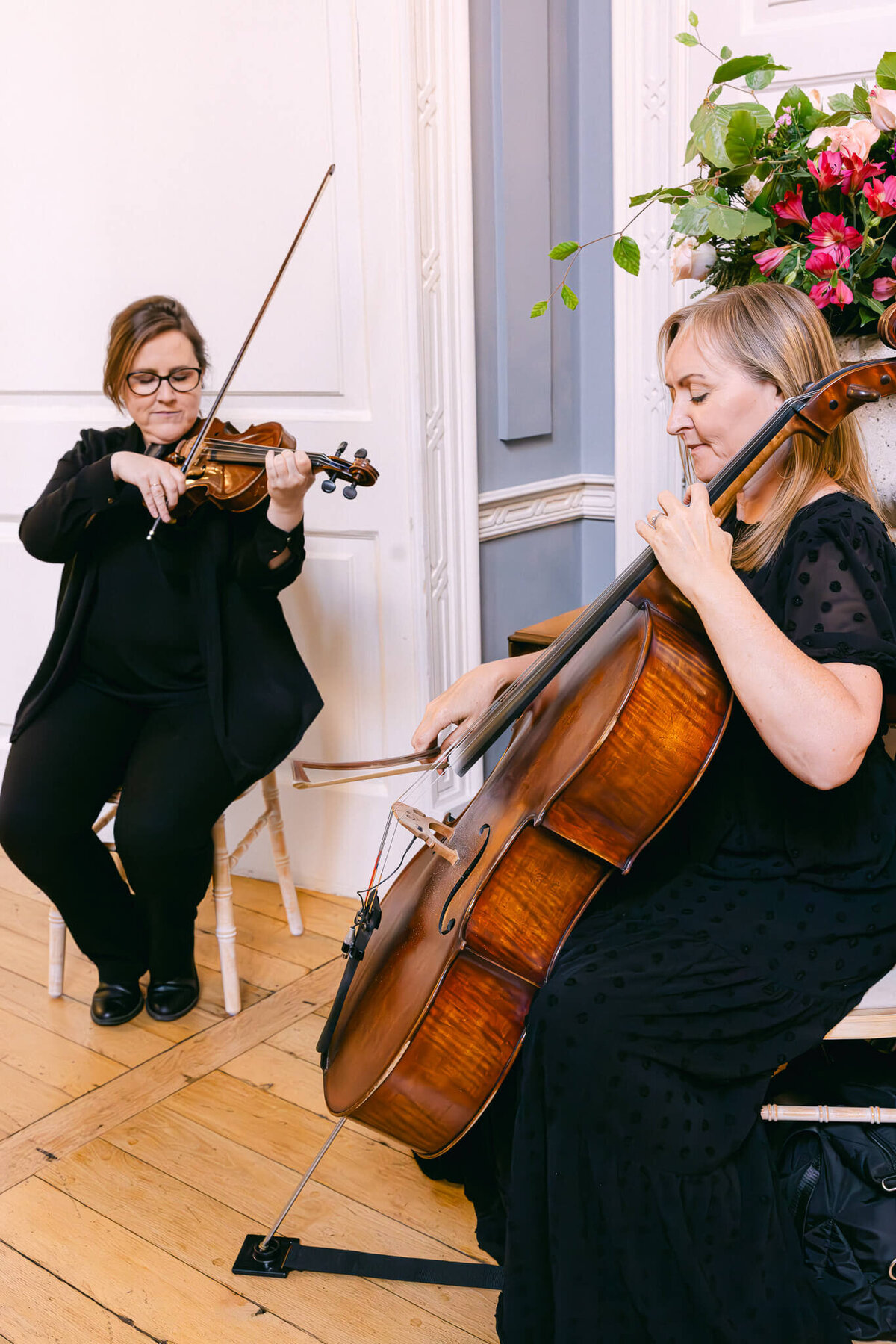 A wedding photo of violinists playing during the ceremony at Luttrellstown Castle