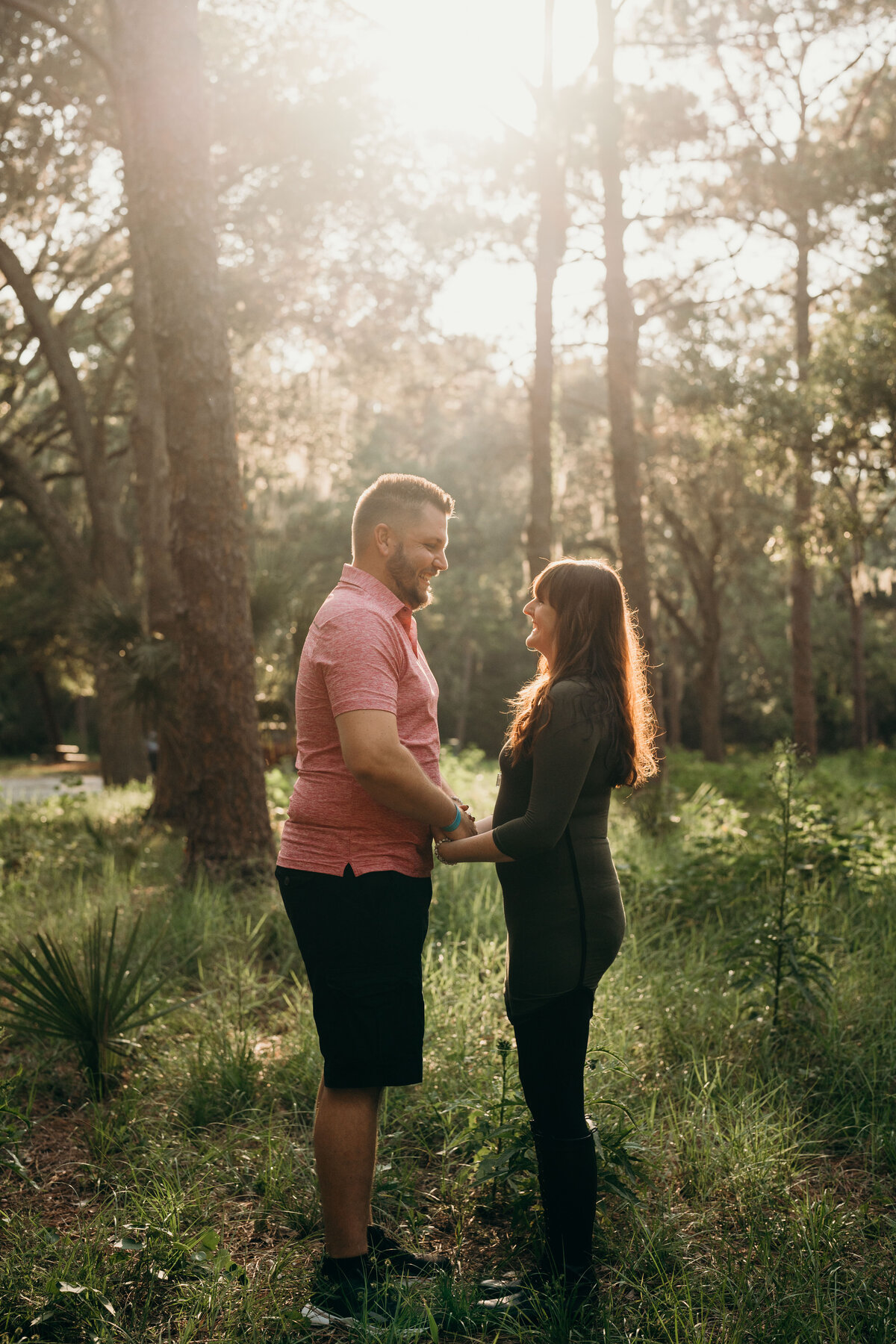 couple holding hands and smiling at john chesnut park during engagement session