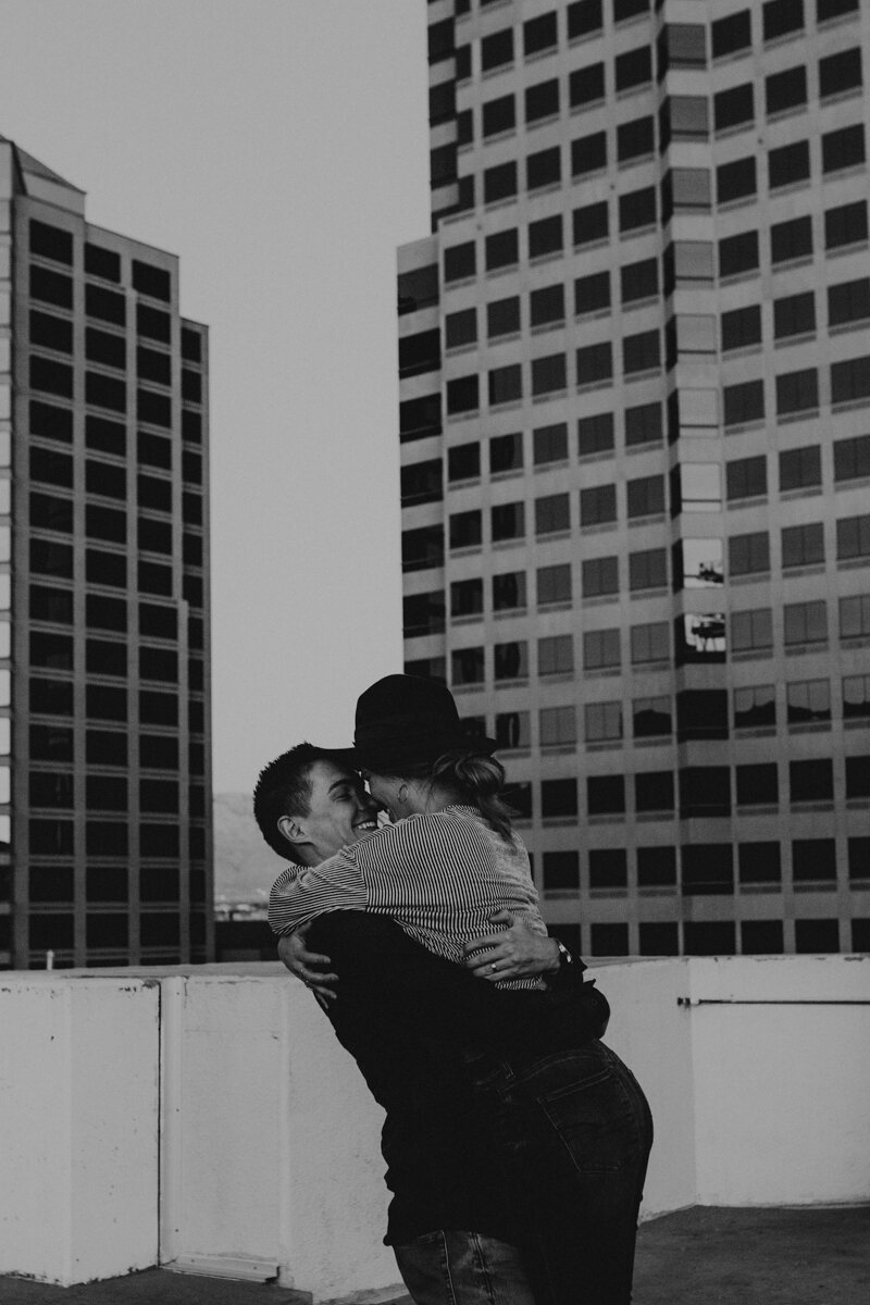 man picking up wife on a rooftop