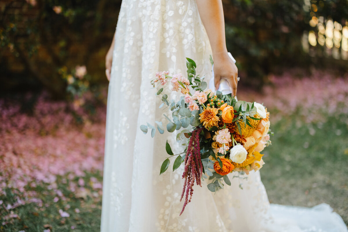 A close up of a colorful bouquet that a bride is holding 