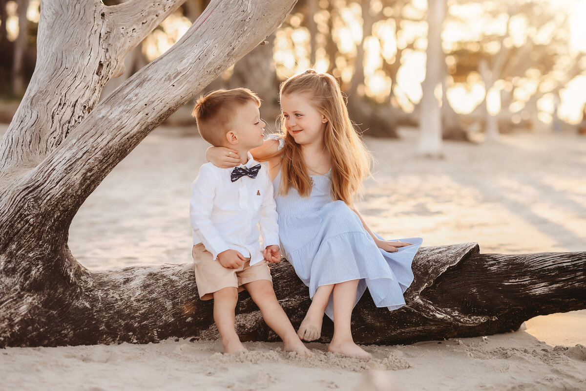 Siblings laugh together during their Family Photos on Folly Beach. 
