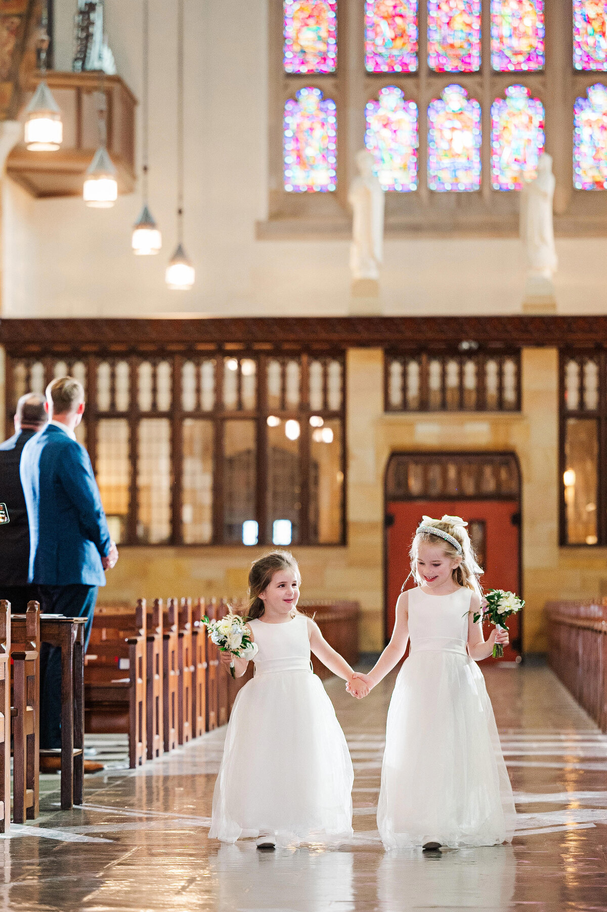 flwoer girls walking down the aisle at sacred heart church
