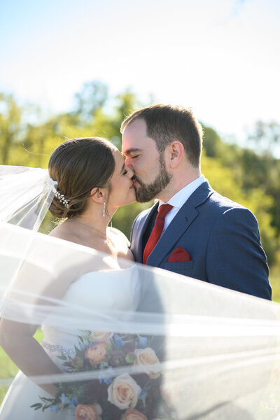 Bride and Groom kiss in outdoor Northern VA Wedding
