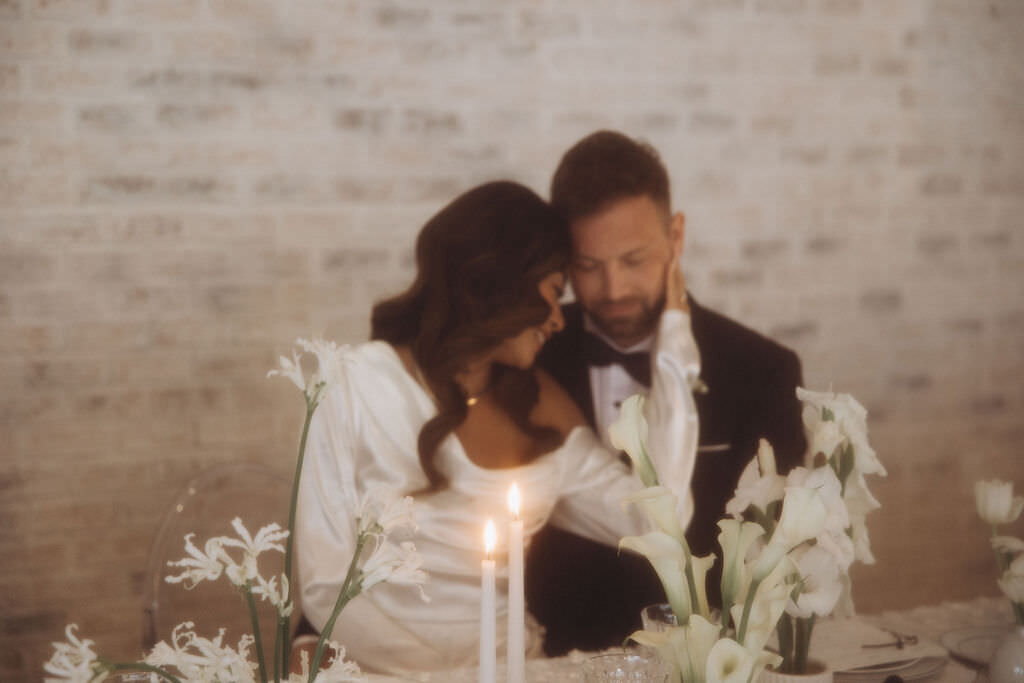 A wedding couple with their heads close together.