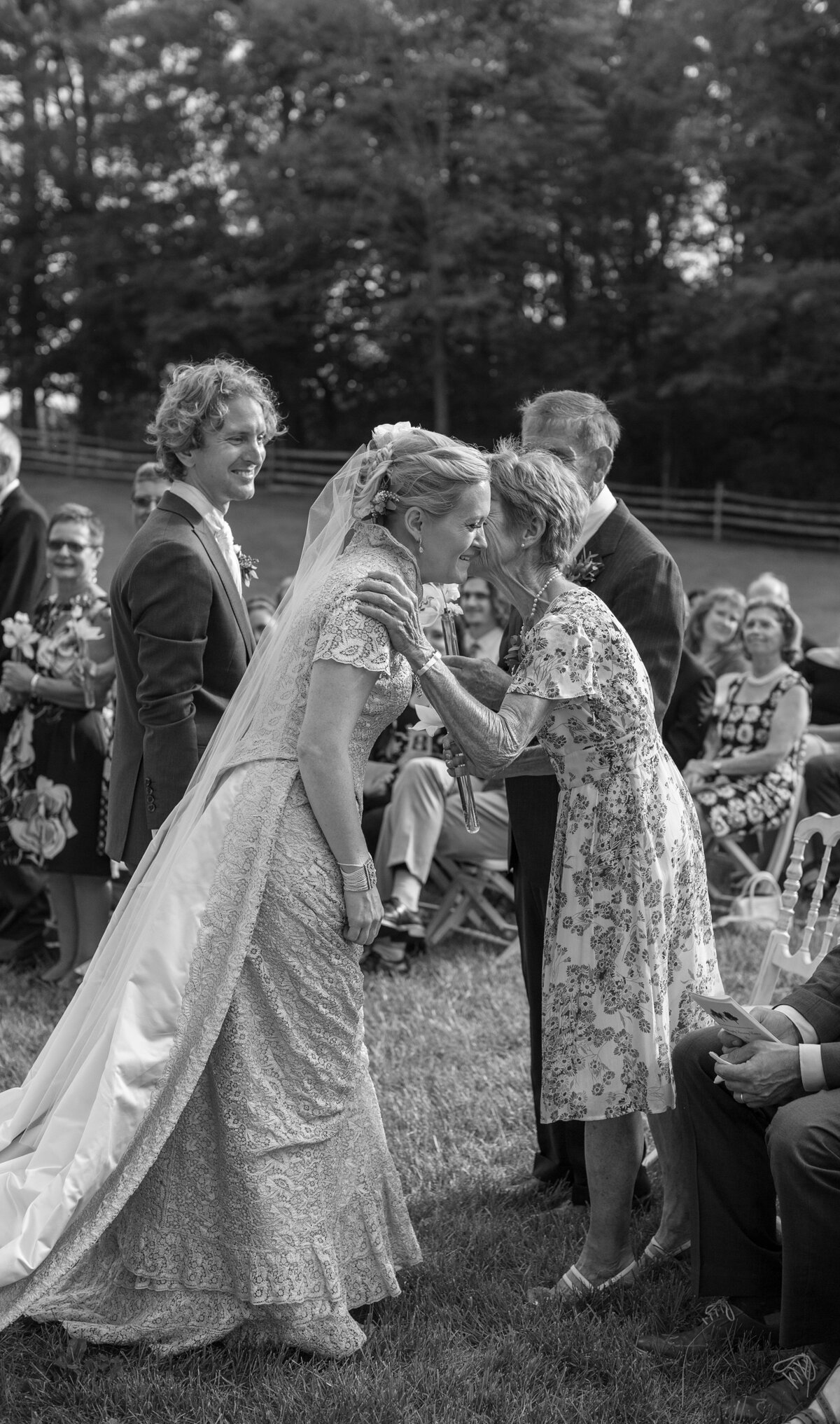 Bride and Groom greet their parents with a kiss during wedding ceremony.
