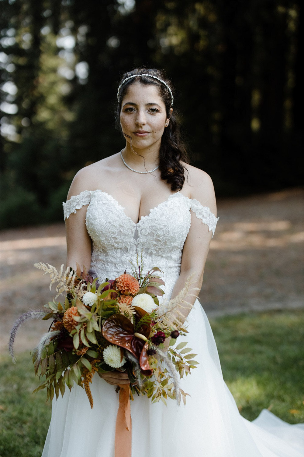 Bride holding her bouquet of orange flowers