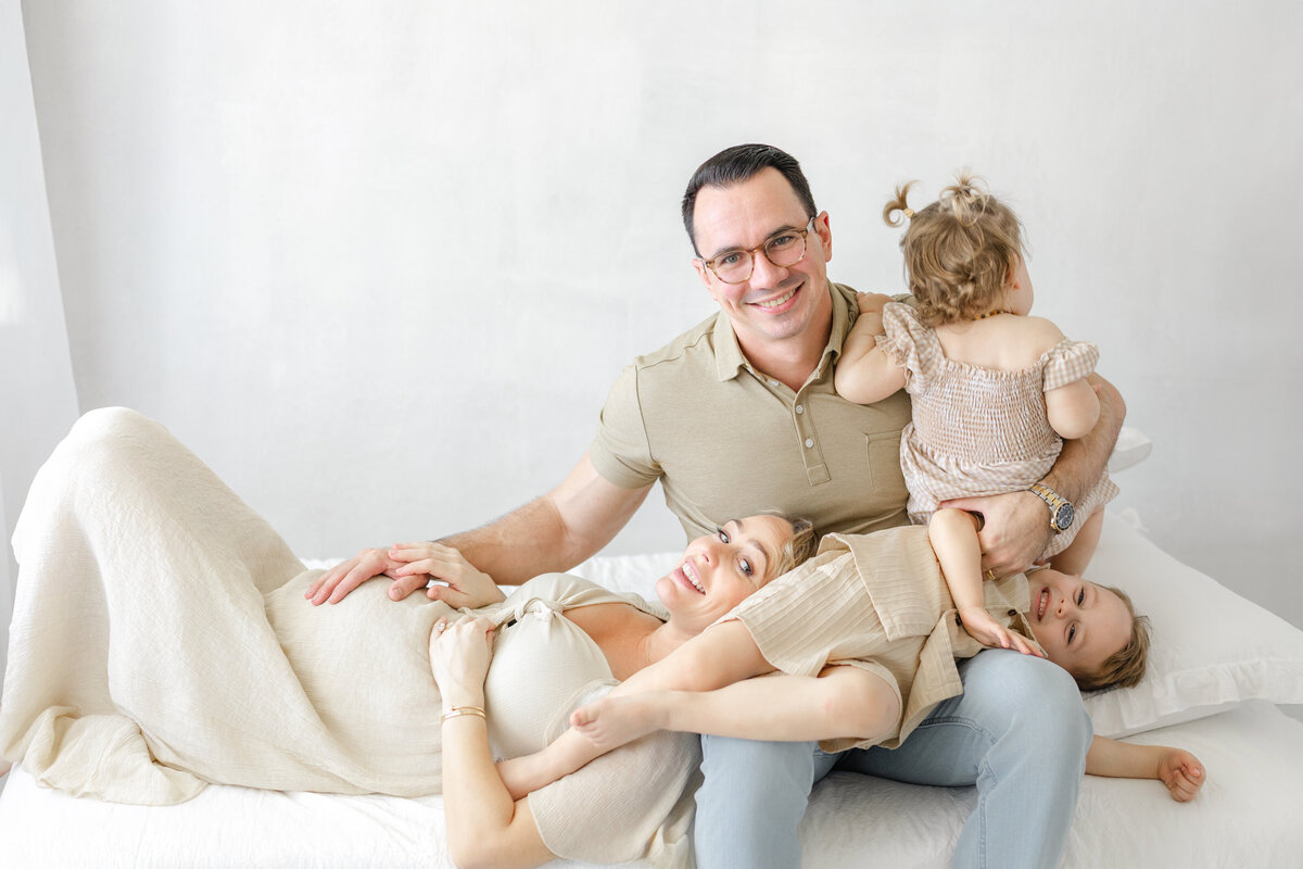 Classic studio maternity portrait of Katie and family, captured in natural light in Tampa