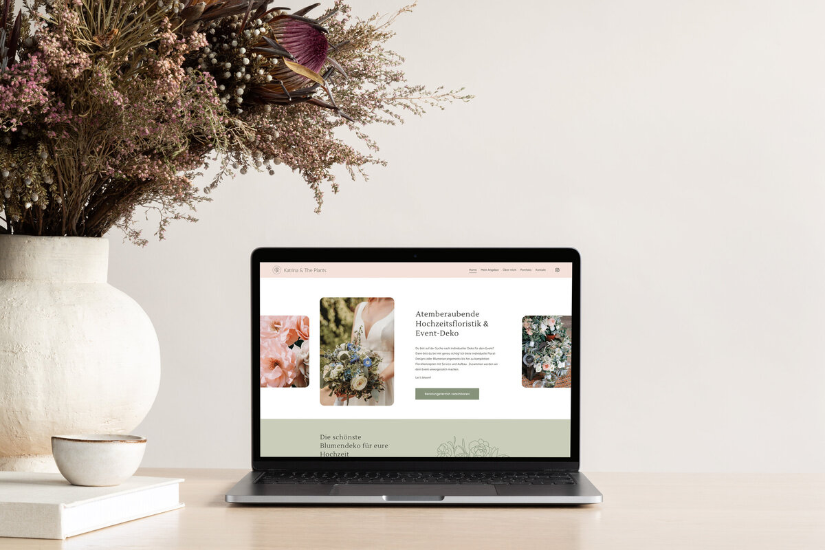 Macbook showing the beautiful, colorful and feminine website of a wedding florist