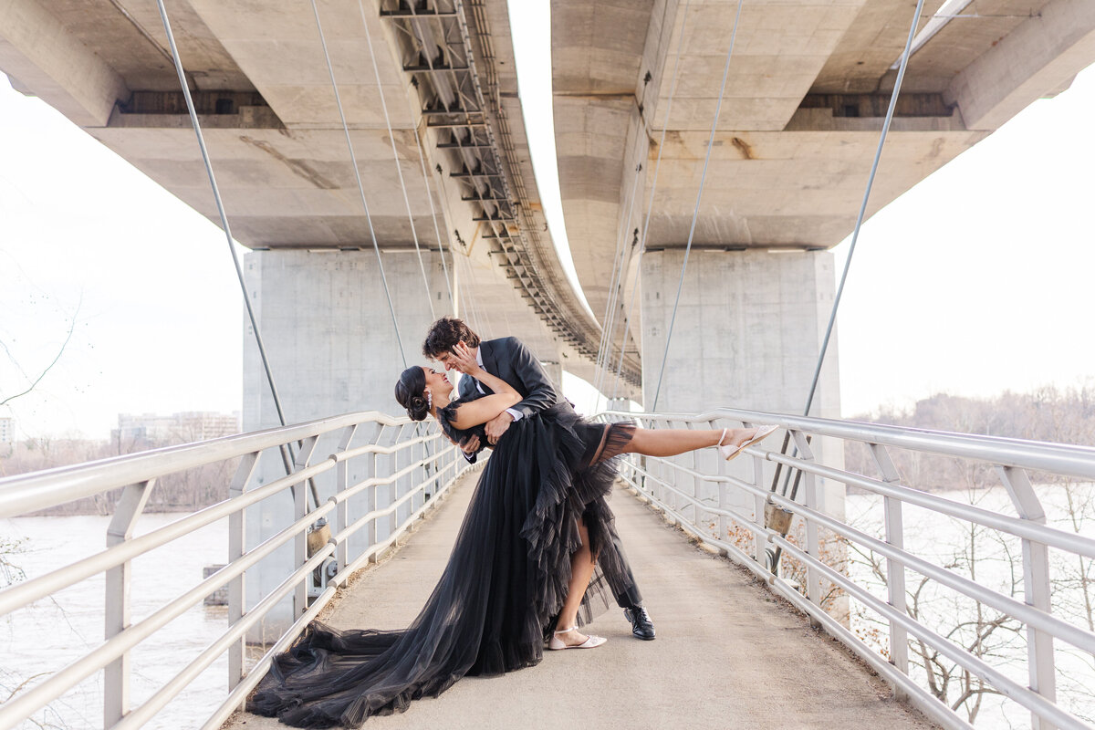 Orlando Florida engaged couple kissing on bridge by engagement photographer Amanda Richardson Photography