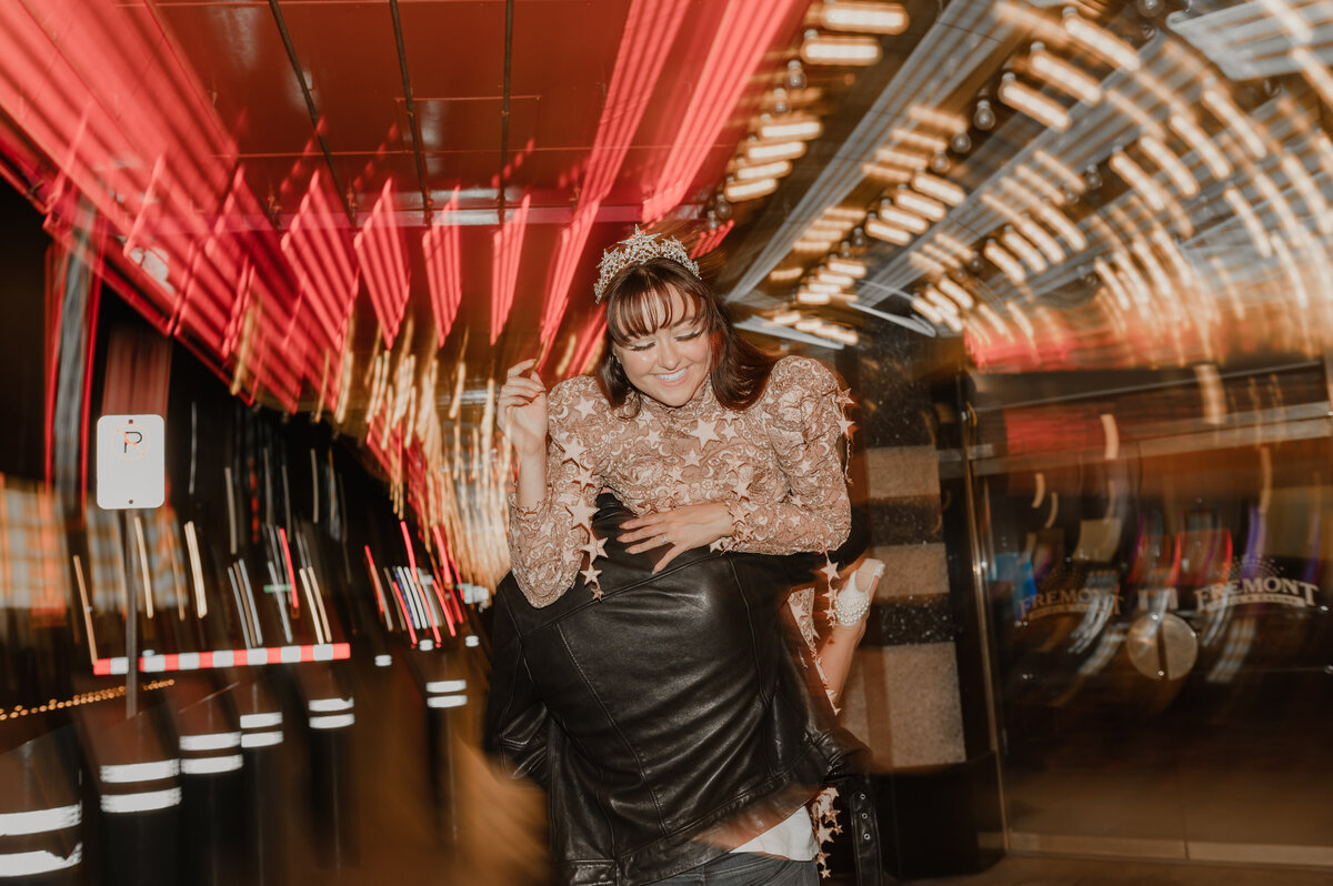 a bride and groom hit the streets of las vegas nevada on fremont street experience with their elopement photographer