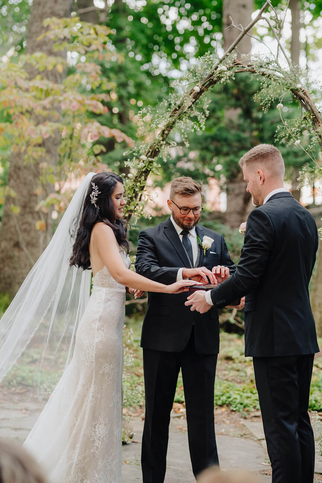 Bride and groom at marriage ceremony in a forest at Finger Lakes, NY