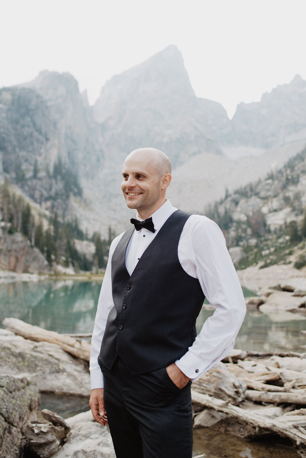 Jackson Hole Photographers capture groom with jacket off smiling