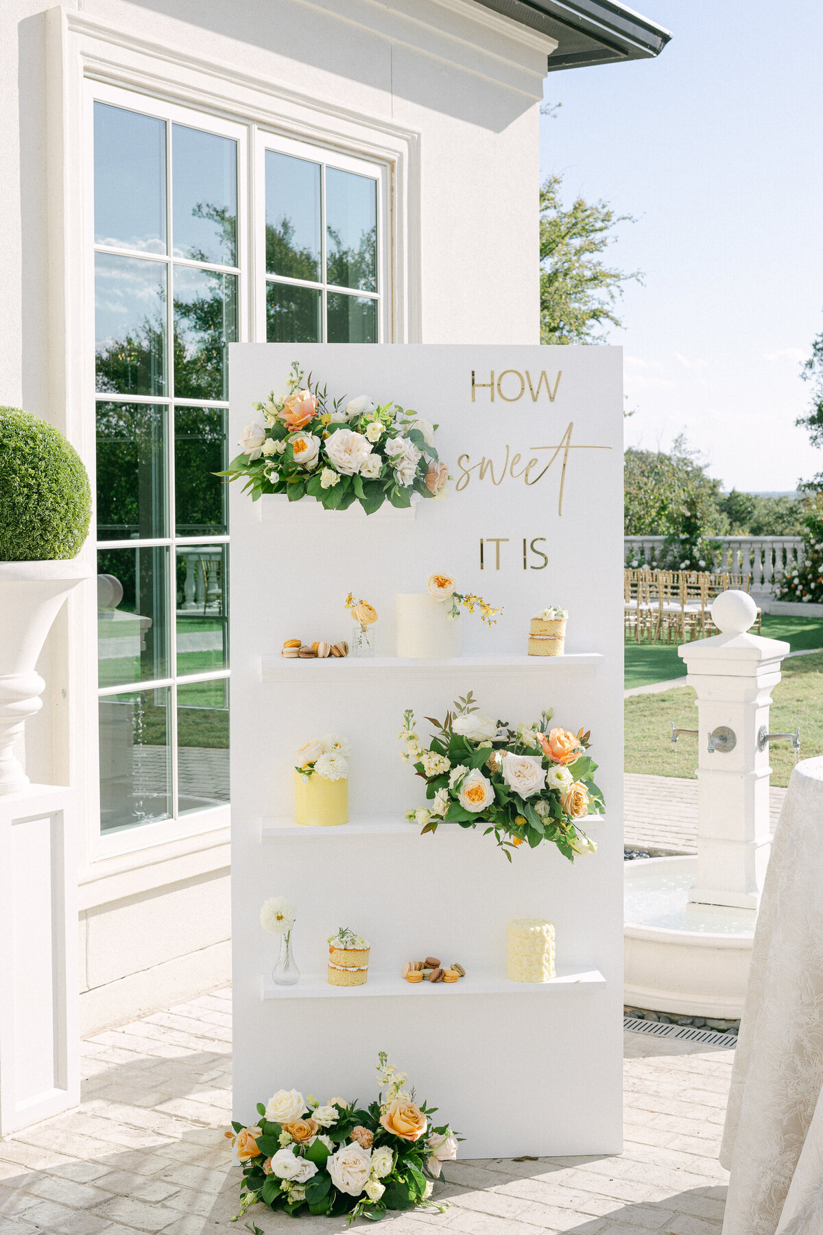 shelves with wedding cake and flowers
