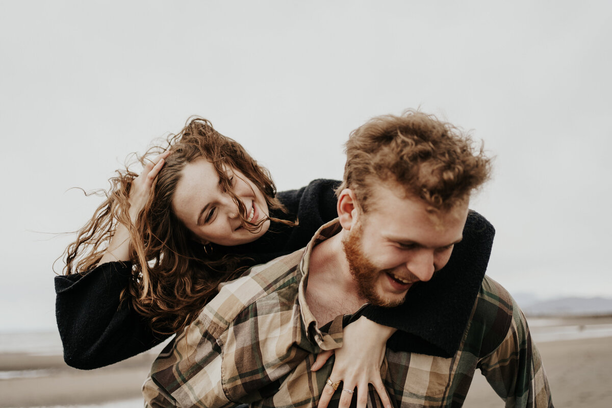 woman hanging on man's back