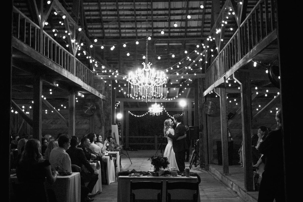 first-dance-under-chandelier-in-barn