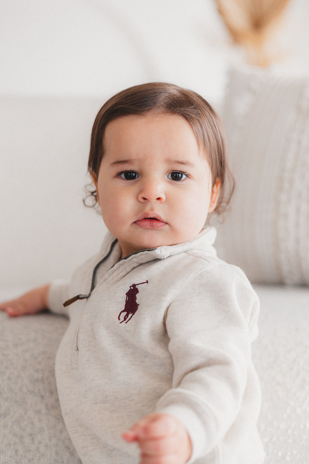 A baby boy looks at the camera.