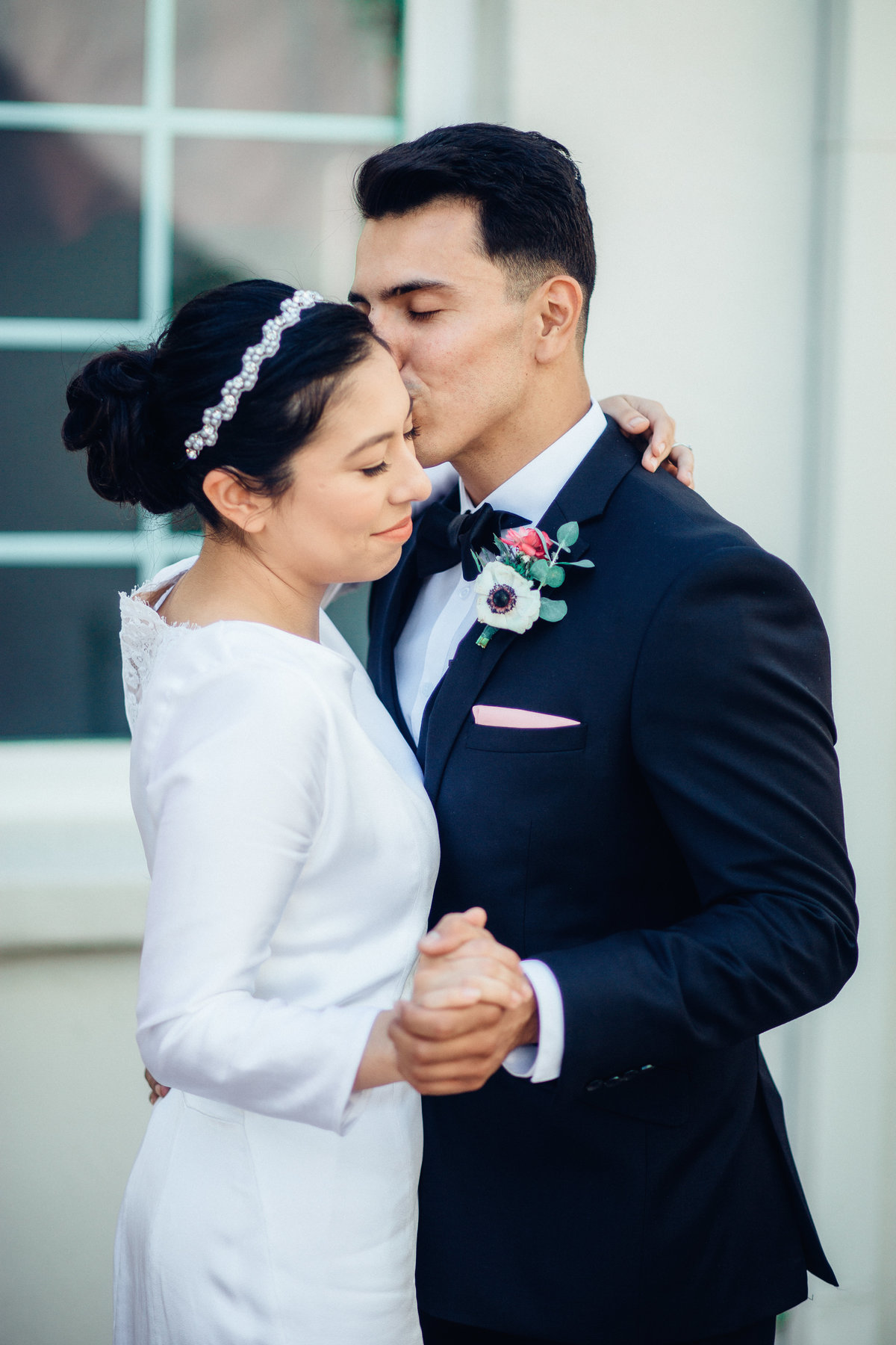 Wedding Photograph Of Groom Kissing His Bride in The Forehead While Dancing Los Angeles