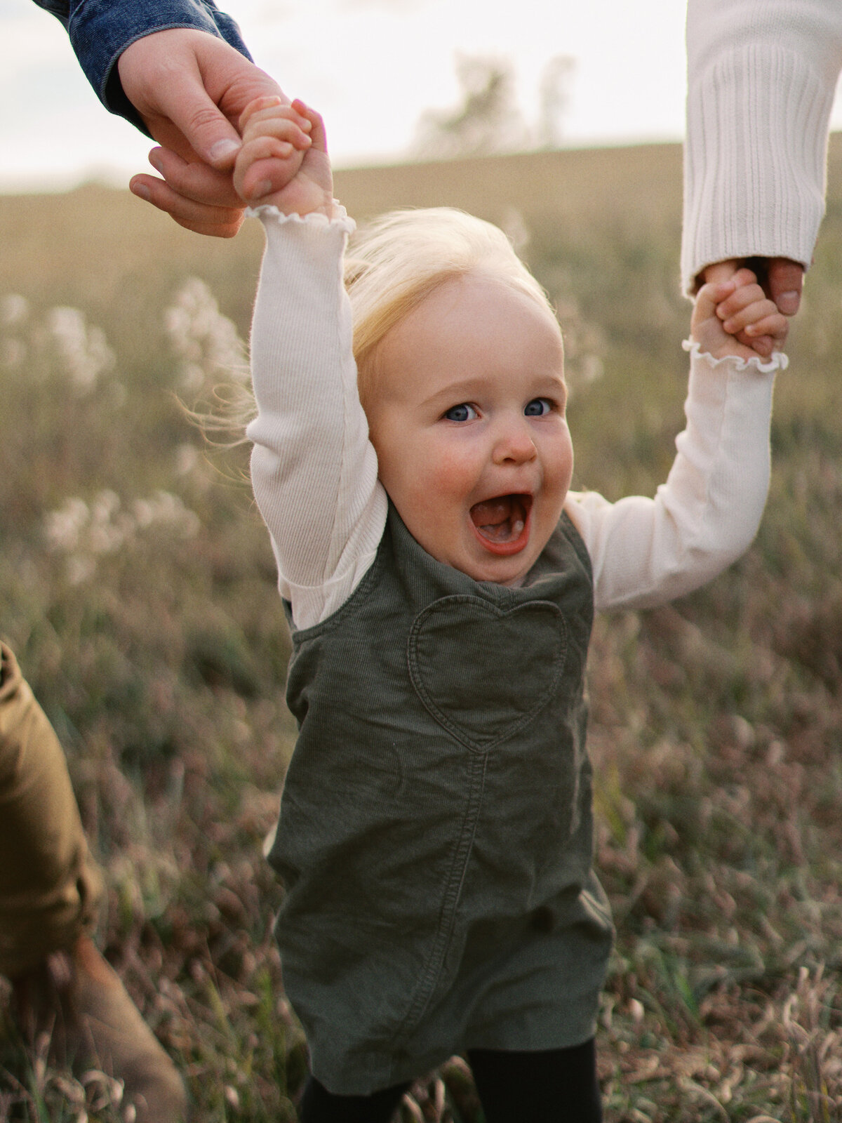 baby-walking-holding-hands-laughing