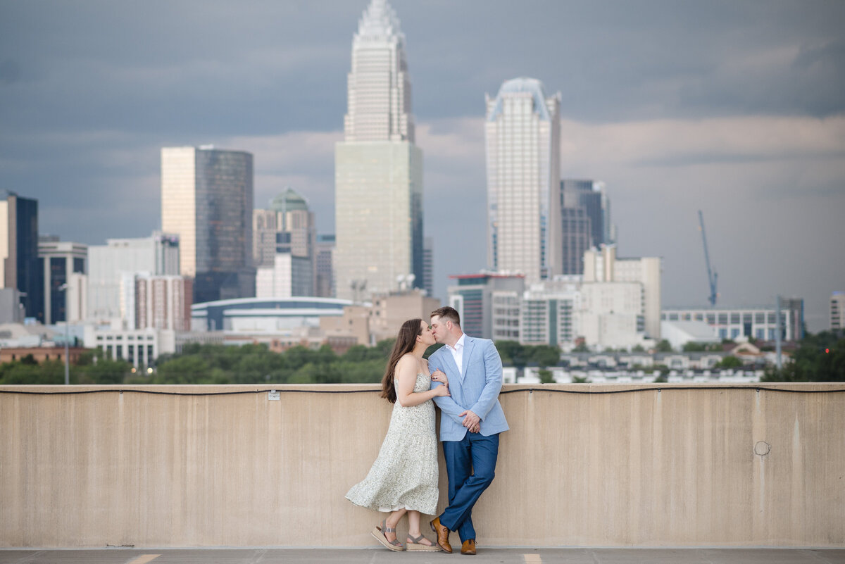 Professional proposal photography in Charlotte NC featuring a rooftop skyline view by DeLong Photography.