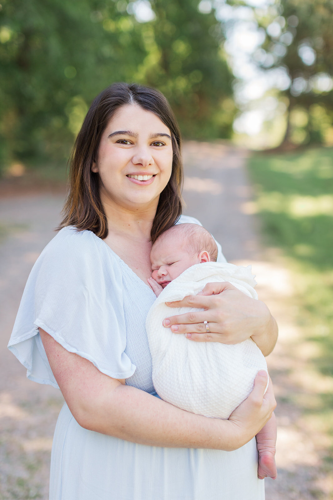 Mom holding newborn during soft morning light