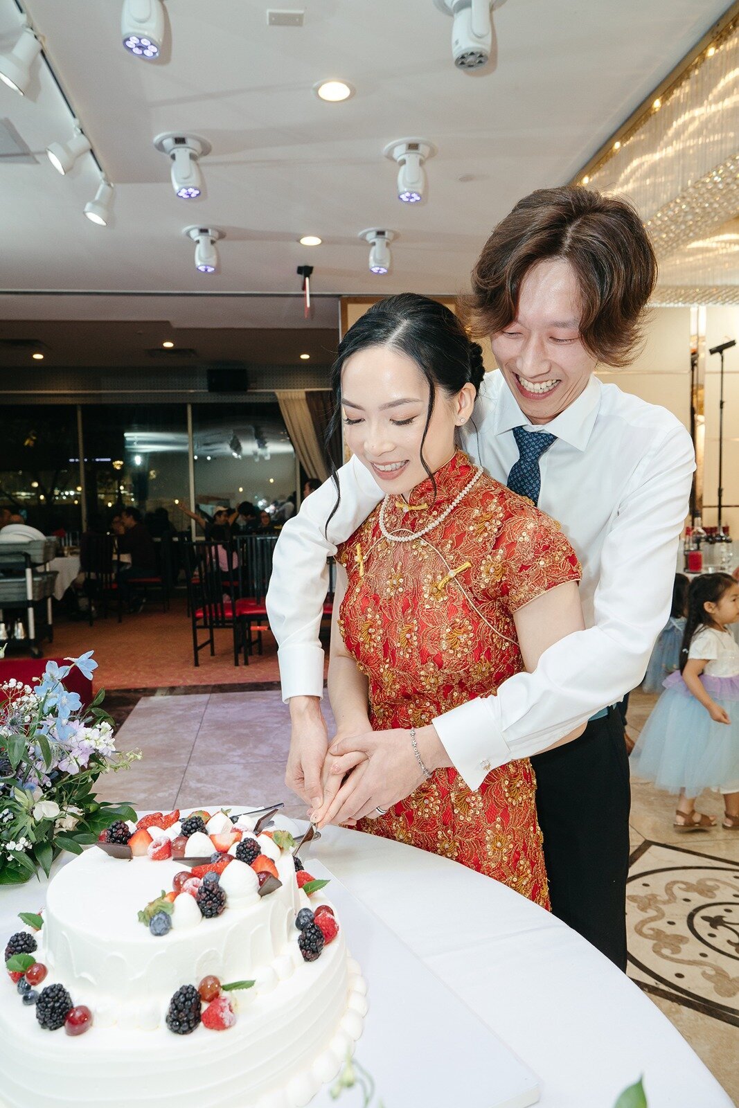 Bride and groom slicing their wedding cake