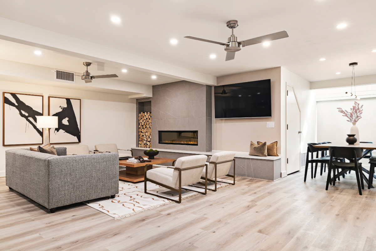 Mountain modern remodel for AirBnb featuring  sled-sleek living room with a cozy view of a ski in ski out resort. Designed by Valt Interiors 2023