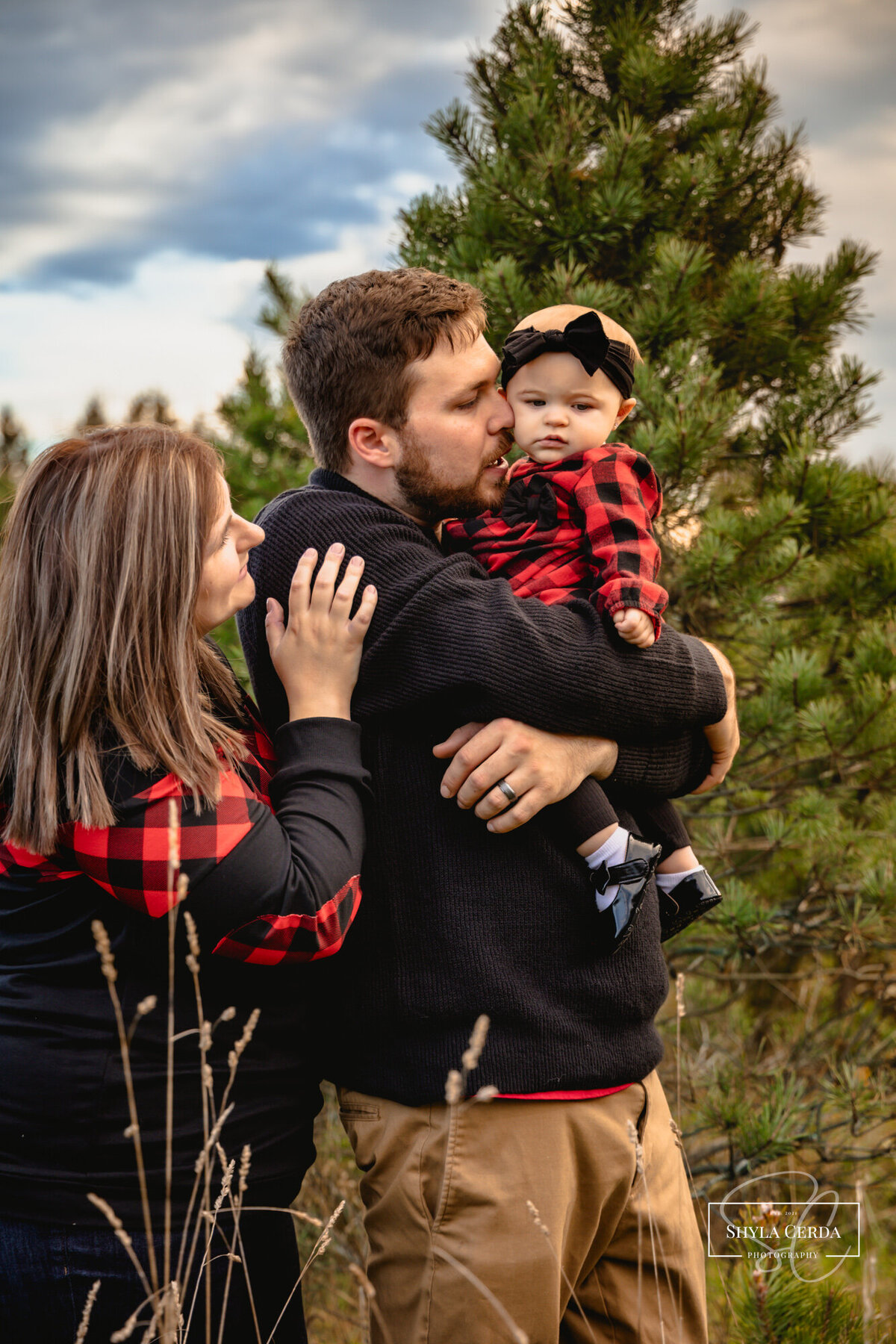 Family together at outdoor tree farm