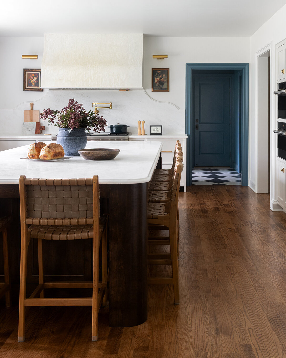 white large island top with wooden high chairs