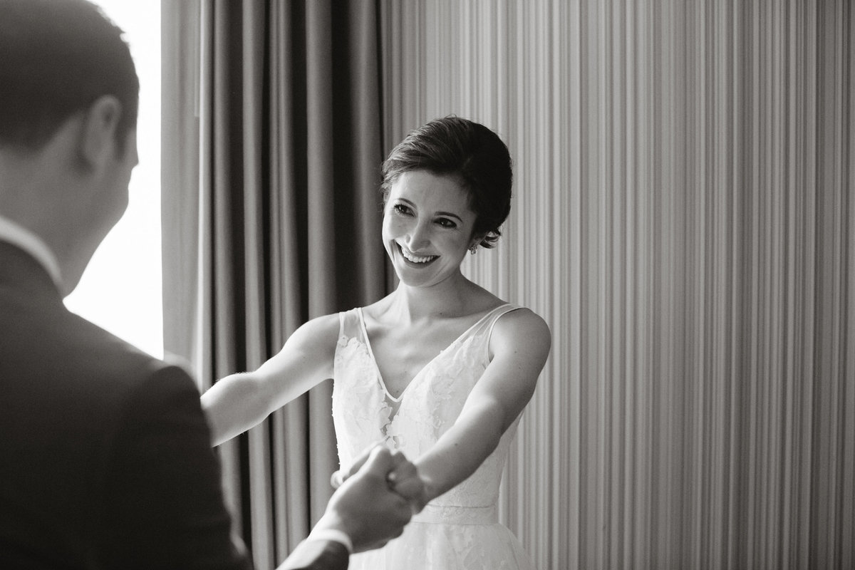Gorgeous bride seeing her man for the first look, captured by Sweetwater.