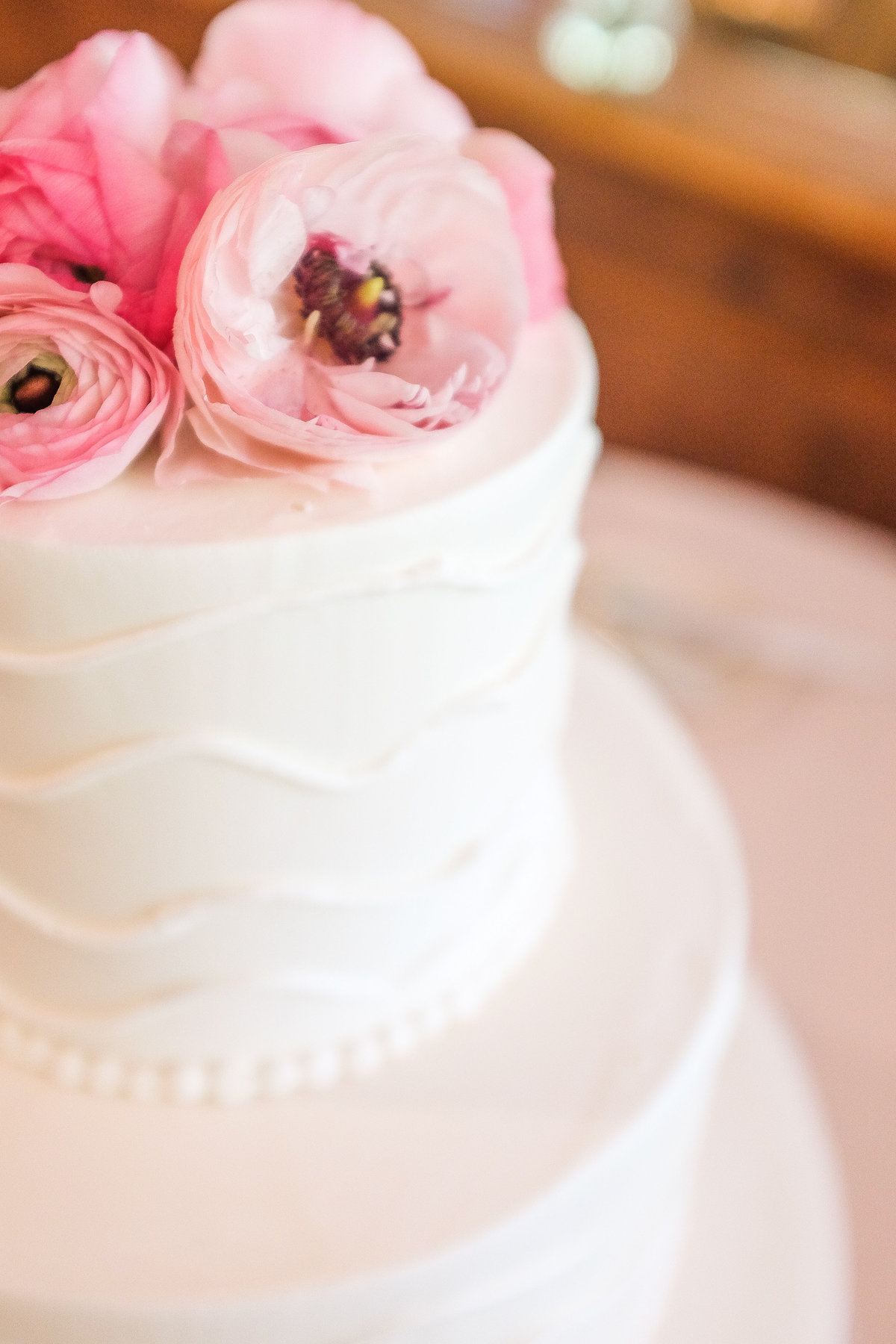 wedding cake with pink flowers on top