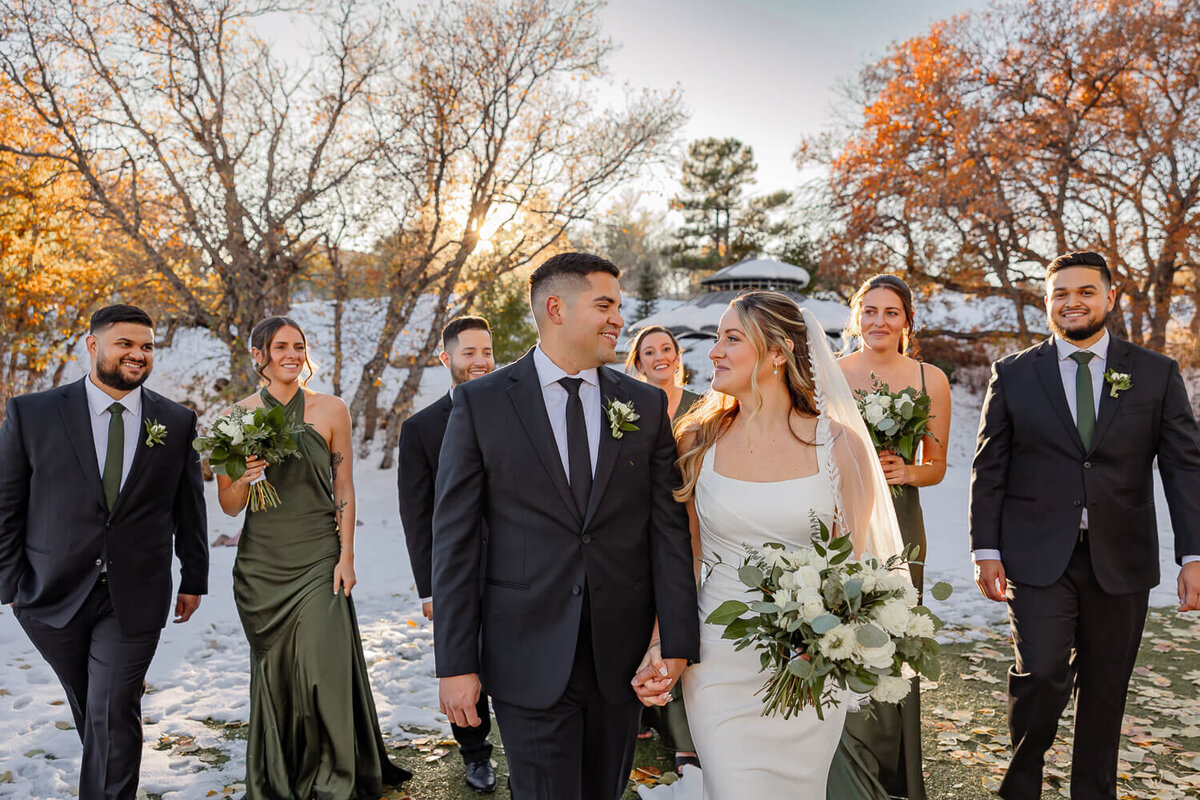 Bridal party group photo of everyone smiling and walking. Captured by Michelle Betz Photography