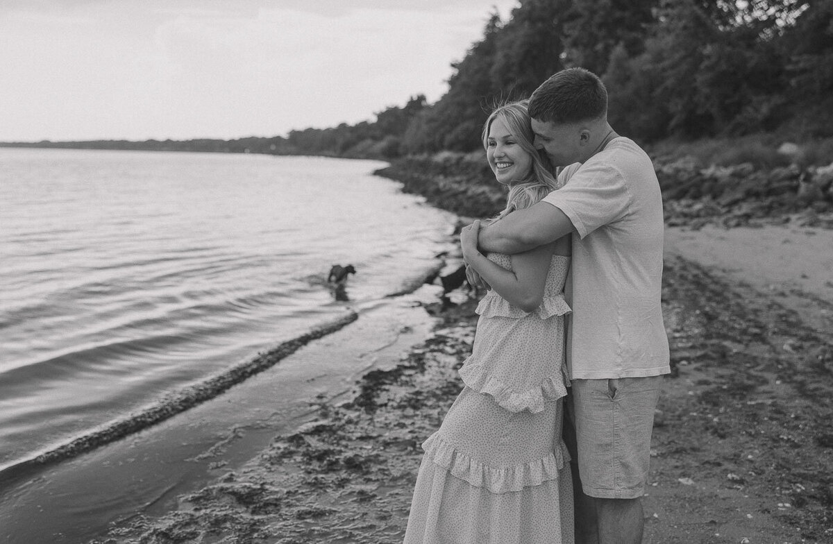 Couple embraces in a hug while at the beach