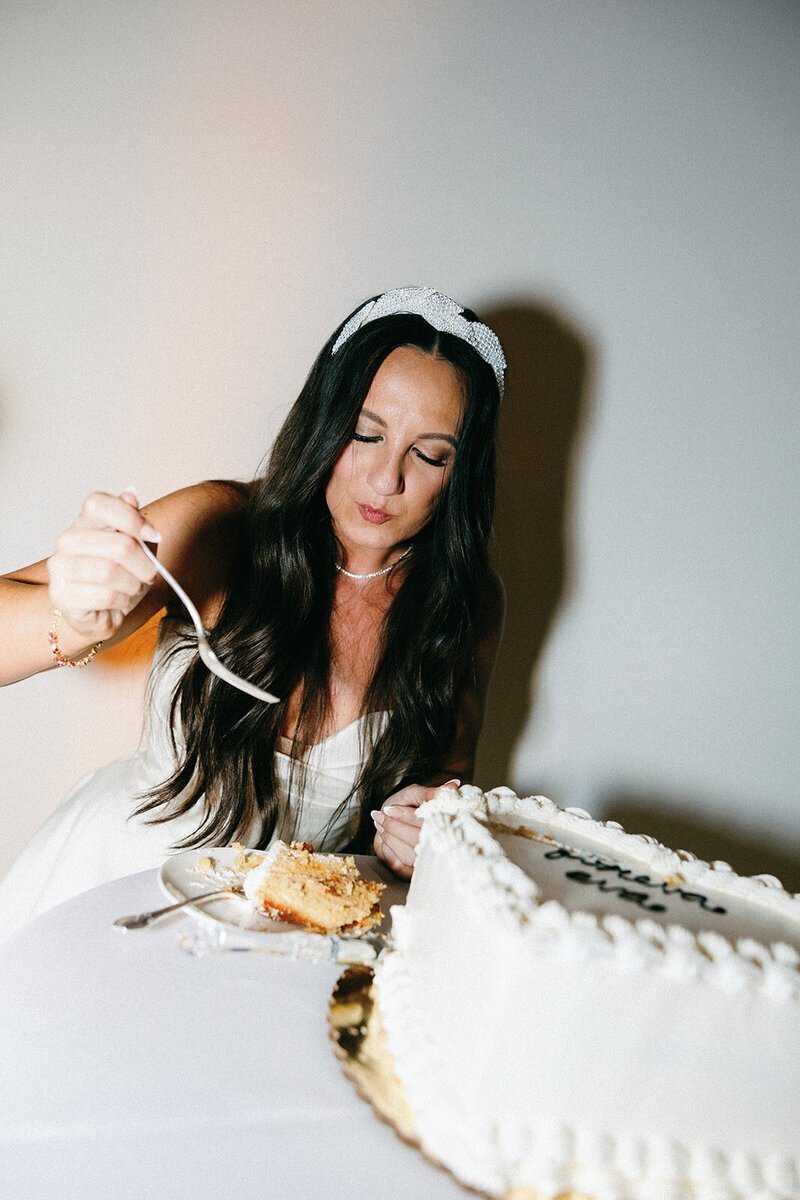Bride eating wedding cake to show penthouse at riverside wharf photos