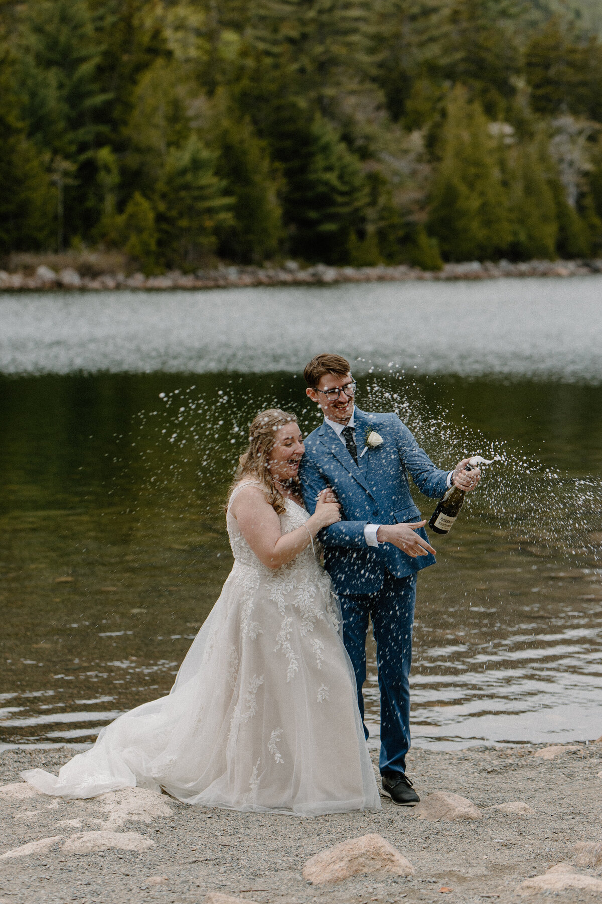 bride and groom popping champagne