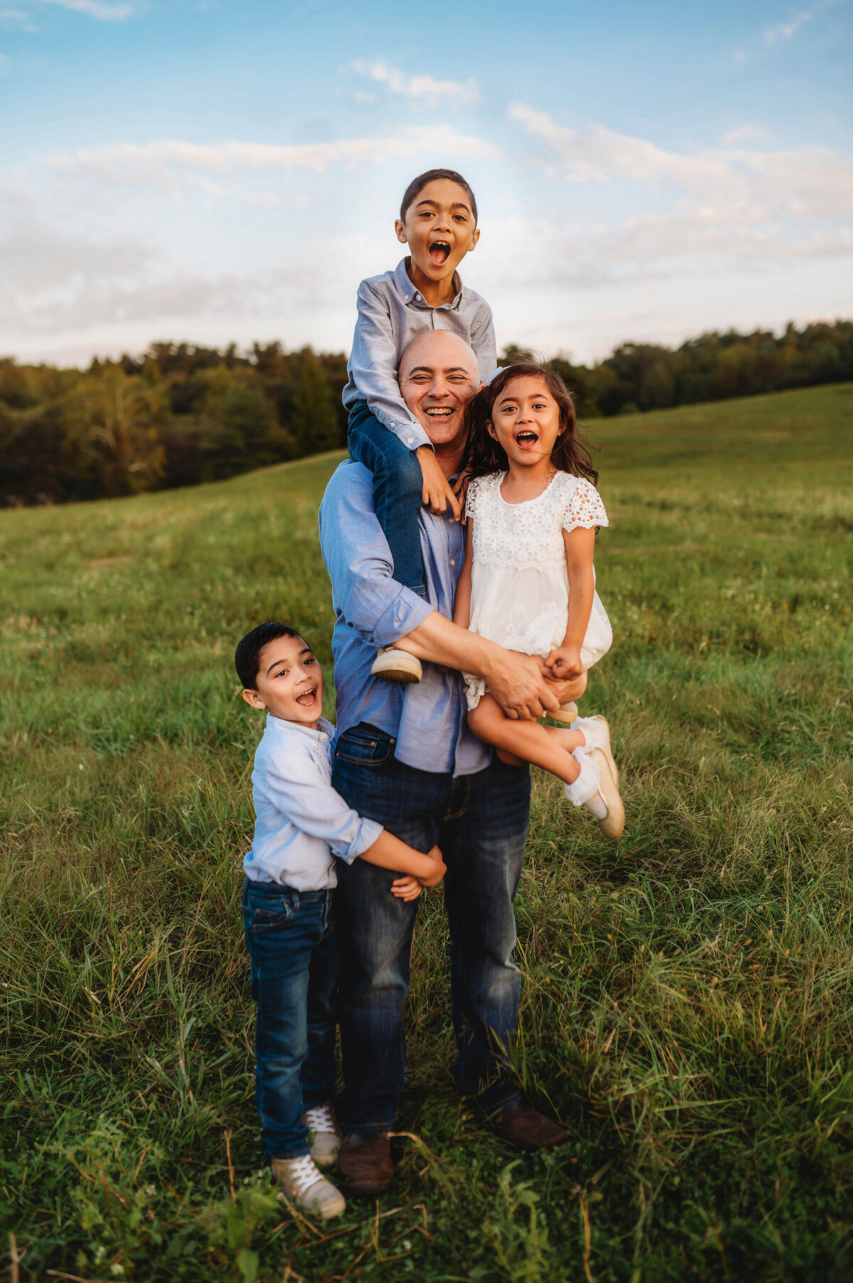 Father holds his children during Family Photos at Biltmore Estate in Asheville, NC.
