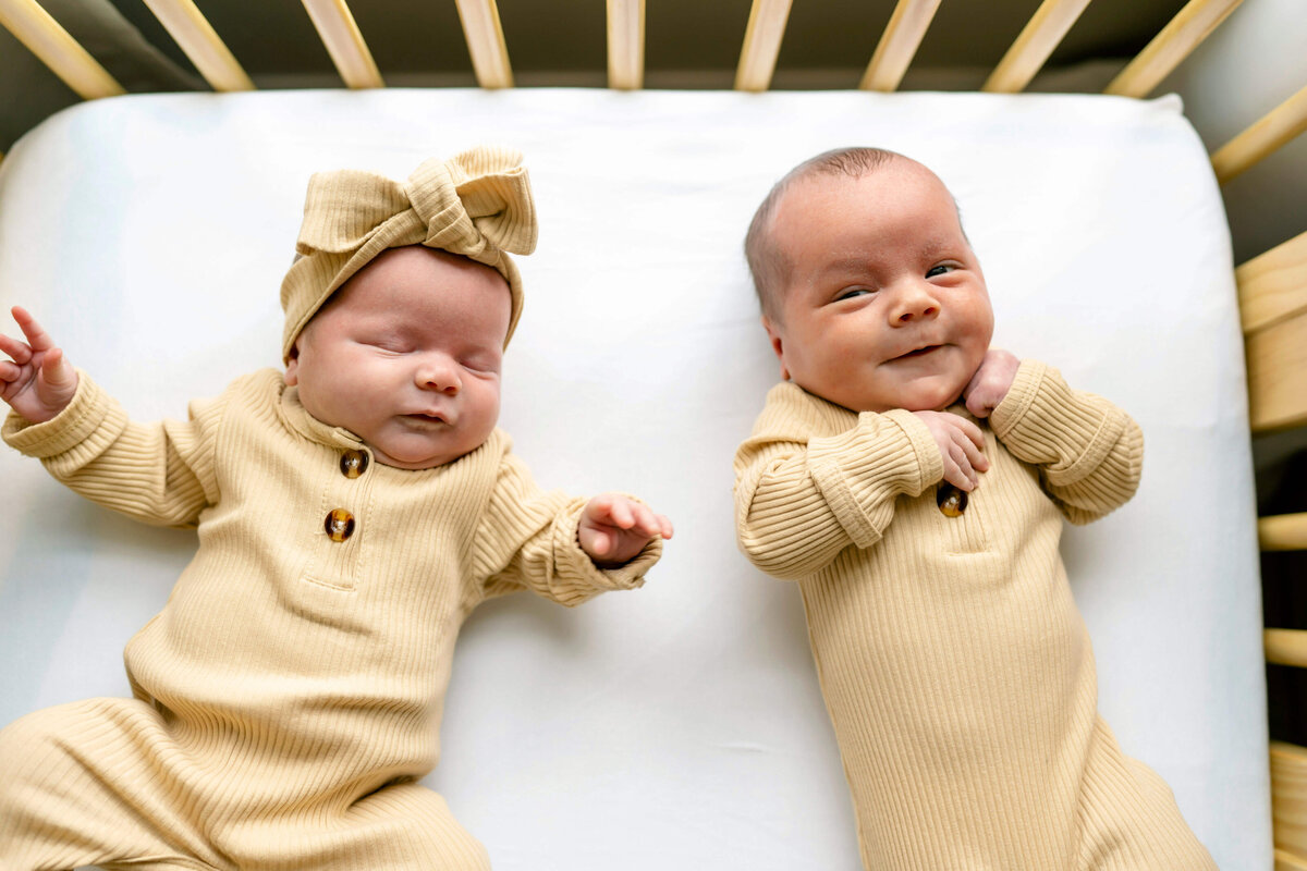 Twin newborns in crib shot from above
