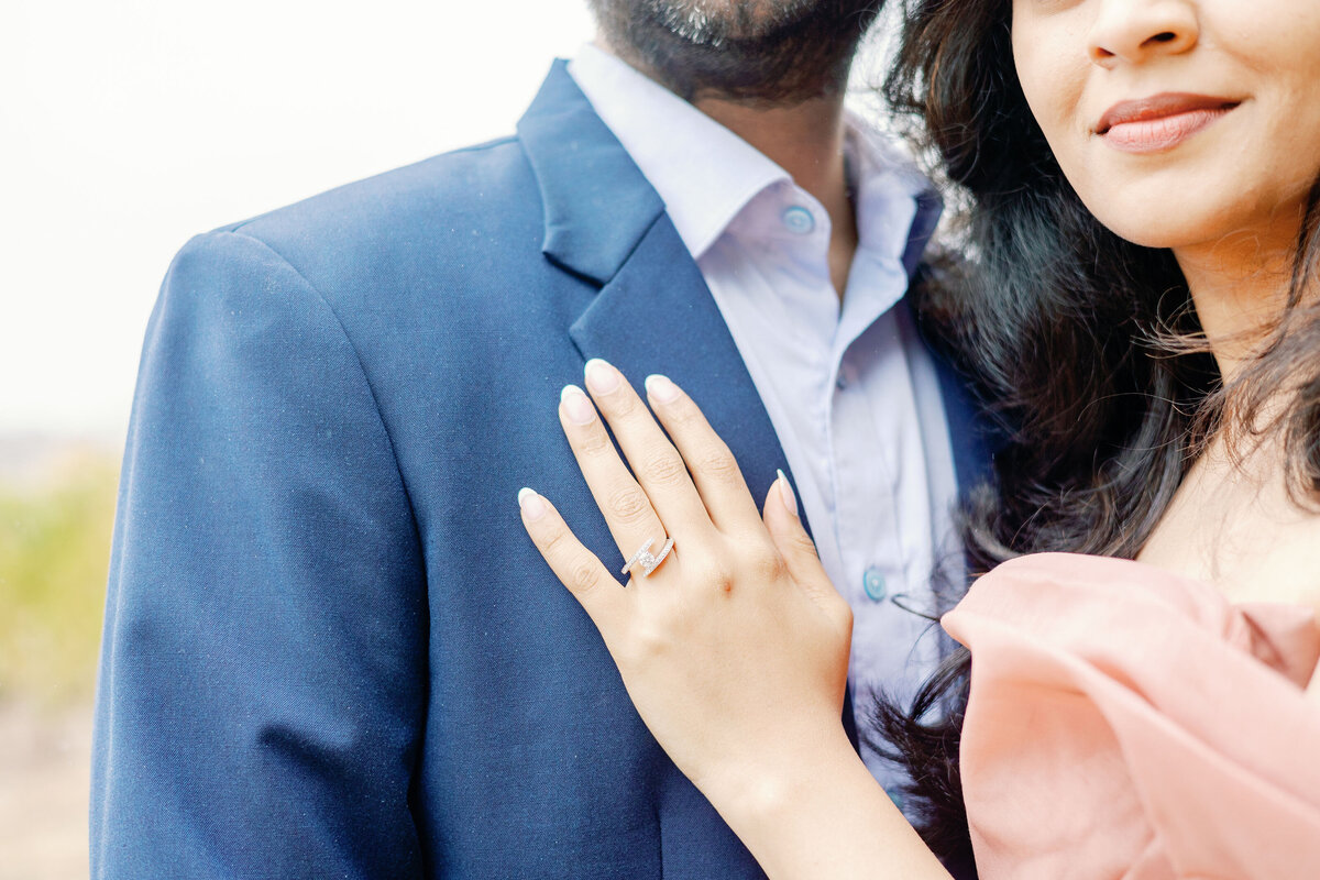 bay area photographers photographs bride and groom embracing and showing off the woman's engagement ring from their proposal pictures